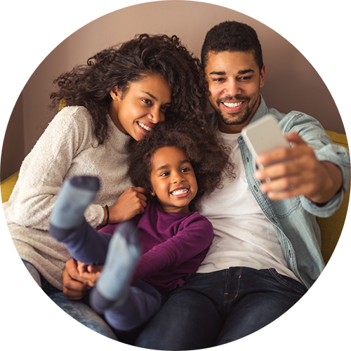 Family of three taking a selfie at home