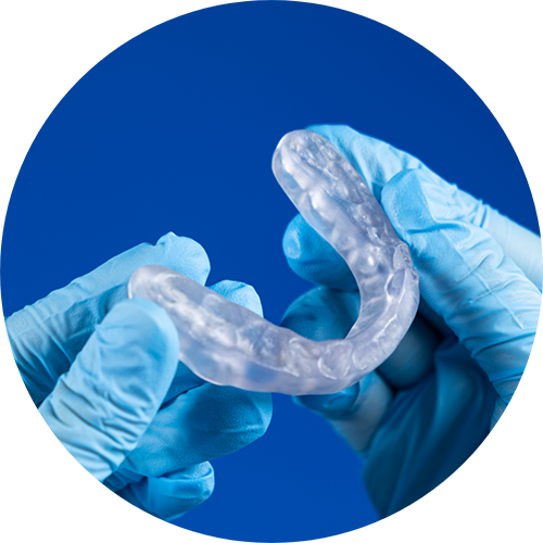 Dentist holding a clear nightguard