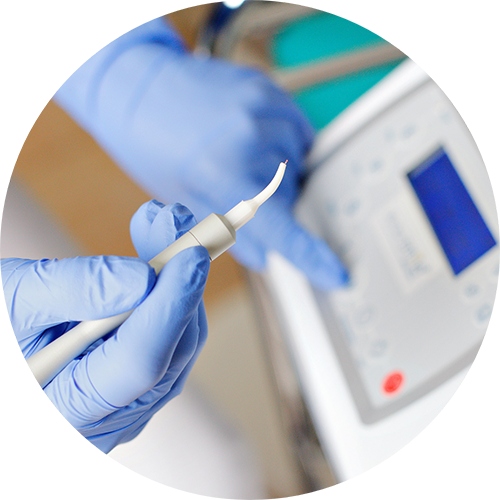 Dental professional holding a pen-like dental laser device