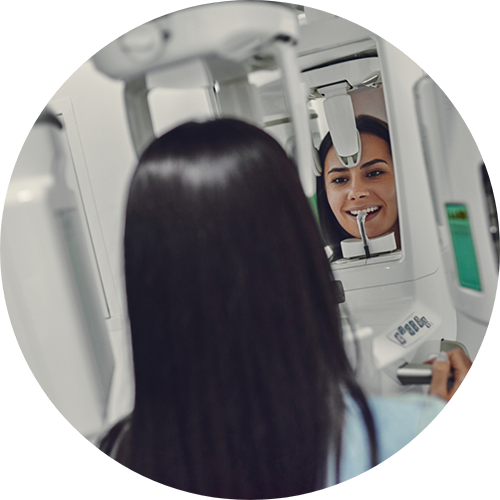 Dental patient getting a CT cone beam scan of her mouth