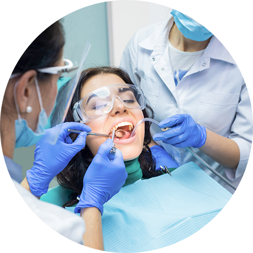 Dentist and dental assistant treating a patient