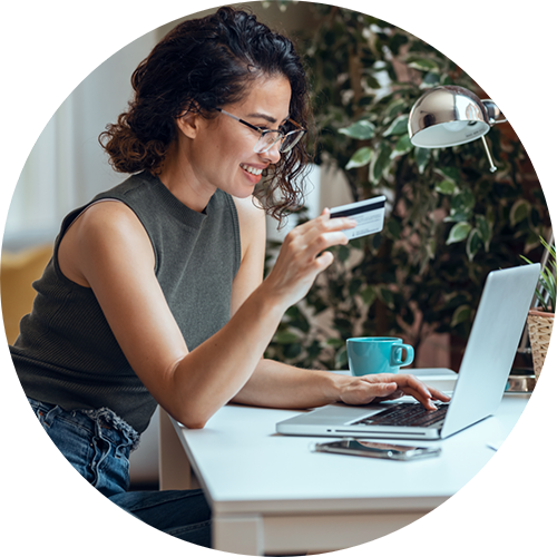 Woman entering her credit card information into a laptop