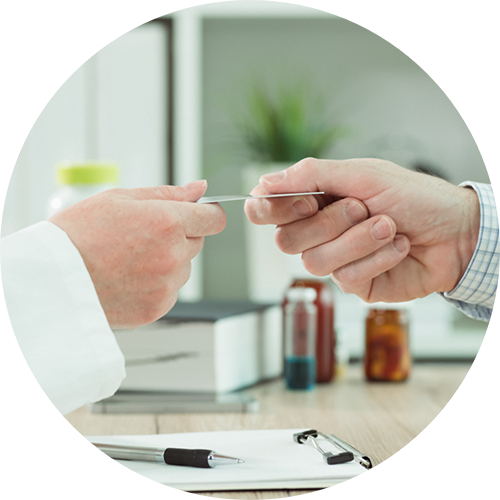 Person handing their payment card to their dentist