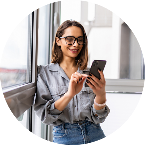 Woman smiling while typing on her phone